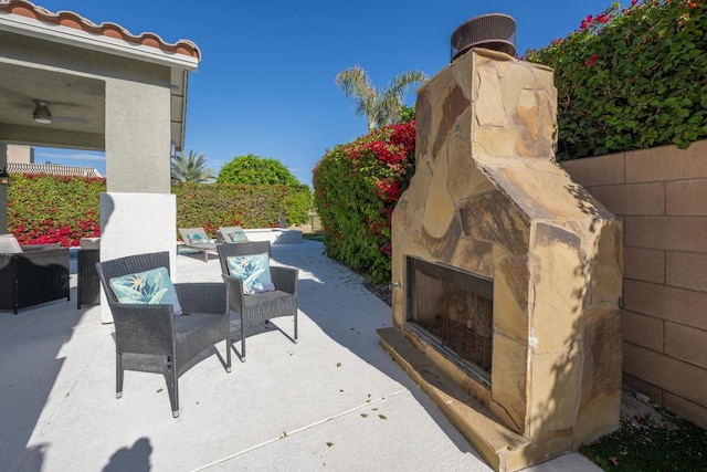 view of patio / terrace with an outdoor stone fireplace