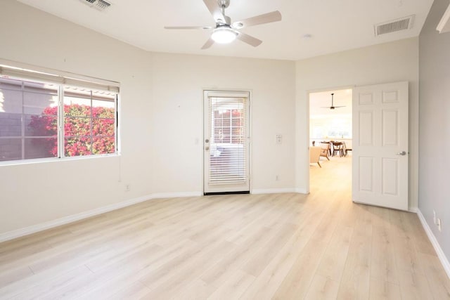 spare room featuring light hardwood / wood-style flooring, plenty of natural light, and ceiling fan