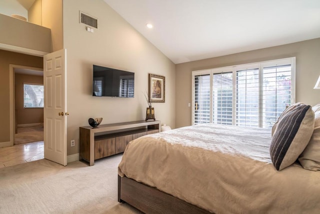 bedroom featuring vaulted ceiling and light colored carpet