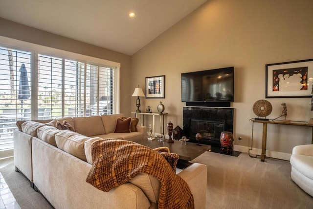 living room featuring vaulted ceiling, light carpet, and a fireplace