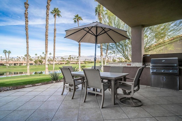 view of patio / terrace with a water view and area for grilling