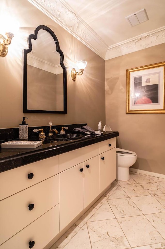 bathroom featuring vanity, ornamental molding, and toilet