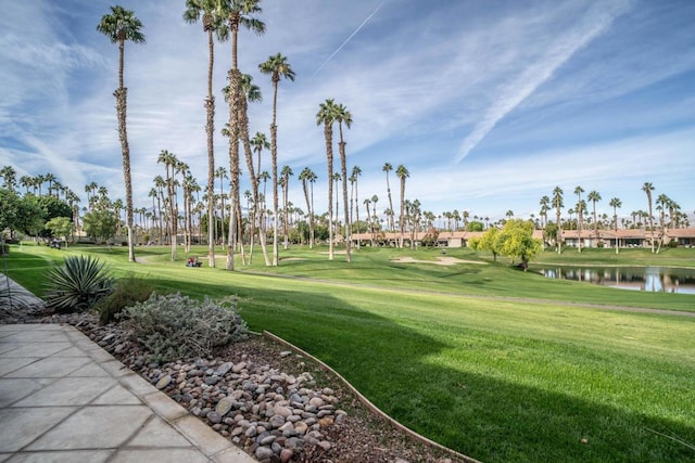 surrounding community featuring a lawn and a water view