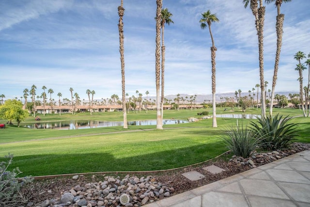 view of property's community with a yard and a water view