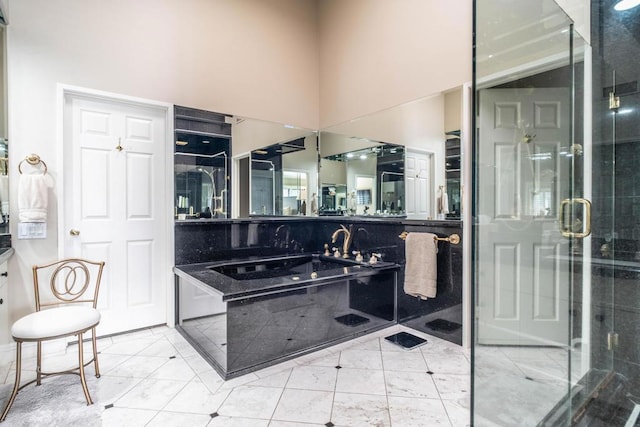 bathroom with a towering ceiling, vanity, and a shower with door