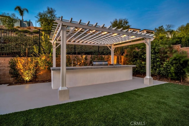 view of patio / terrace featuring exterior kitchen, exterior bar, and a pergola