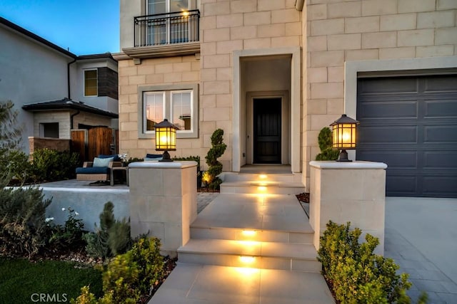 doorway to property with a garage