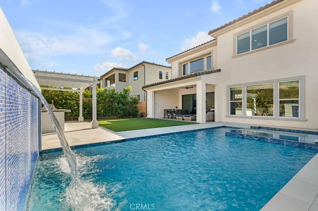 view of swimming pool featuring ceiling fan, outdoor lounge area, pool water feature, a pergola, and a patio