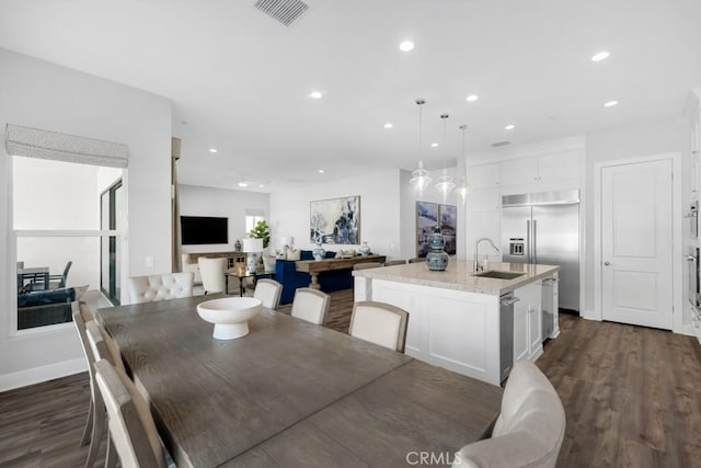 dining room featuring sink and dark hardwood / wood-style flooring