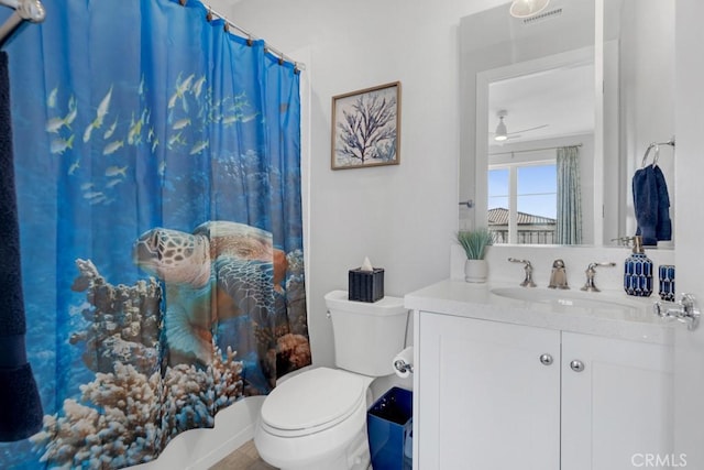 bathroom with toilet, vanity, and ceiling fan