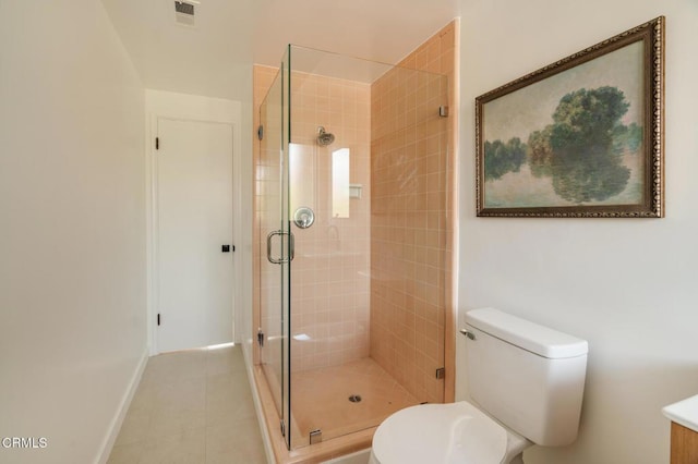 bathroom with tile patterned flooring, toilet, and an enclosed shower