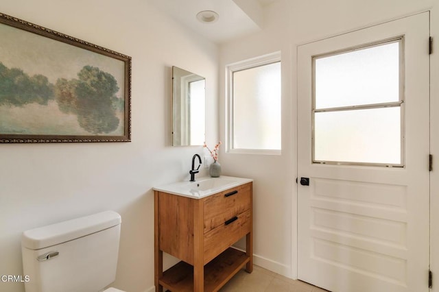 bathroom with tile patterned floors, vanity, and toilet