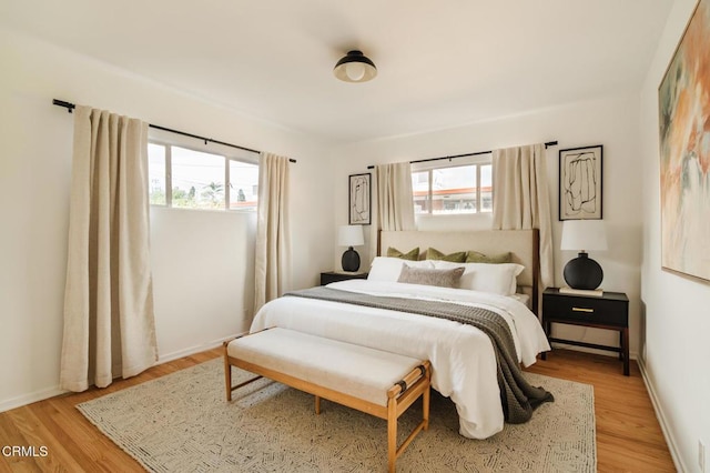 bedroom featuring light wood-type flooring and multiple windows