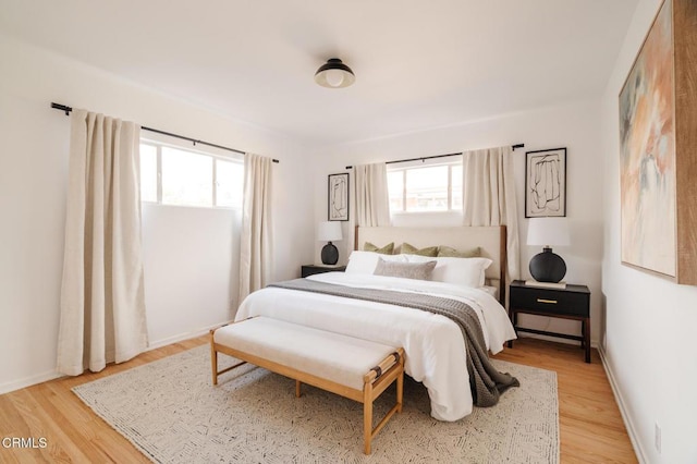 bedroom featuring light hardwood / wood-style floors and multiple windows