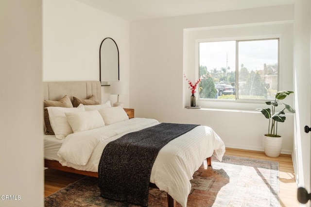 bedroom with hardwood / wood-style floors