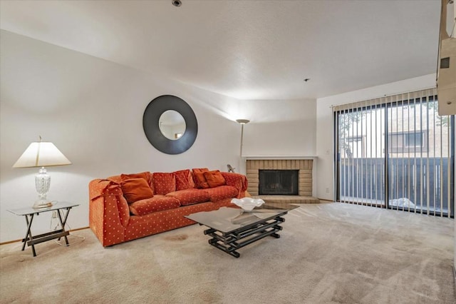 carpeted living room with a brick fireplace