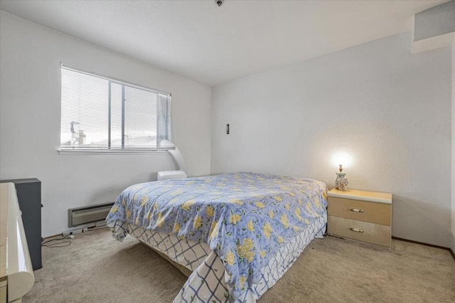 carpeted bedroom featuring baseboard heating