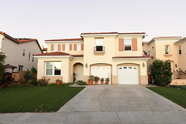 mediterranean / spanish-style home with a front yard and a garage