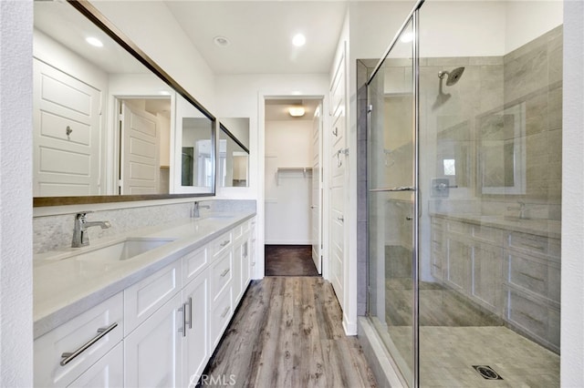 bathroom with vanity, wood-type flooring, and walk in shower