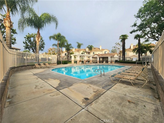 912 N Turner Ave Unit 58, Ontario, CA 91764 - community pool with fence, a residential view, and a patio area