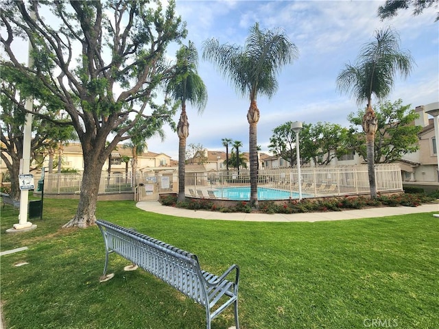 912 N Turner Ave Unit 58, Ontario, CA 91764 - view of property's community with a lawn, a swimming pool, and fence