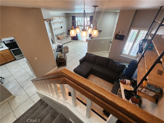 912 N Turner Ave Unit 58, Ontario, CA 91764 - living room with a textured ceiling, a chandelier, and light tile patterned floors