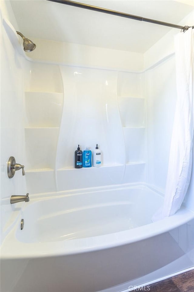 bathroom featuring shower / tub combo and hardwood / wood-style flooring