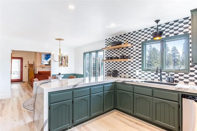 kitchen with dishwasher, hanging light fixtures, tasteful backsplash, light hardwood / wood-style floors, and kitchen peninsula