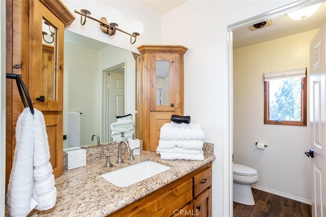 bathroom featuring vanity, toilet, and wood-type flooring