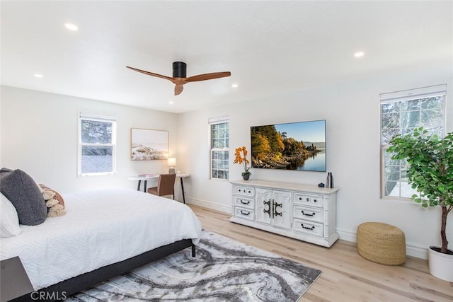 bedroom with light hardwood / wood-style flooring and ceiling fan