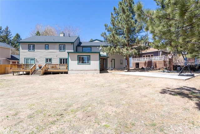 back of house with a wooden deck