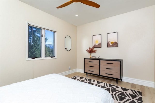 bedroom with ceiling fan and light hardwood / wood-style floors