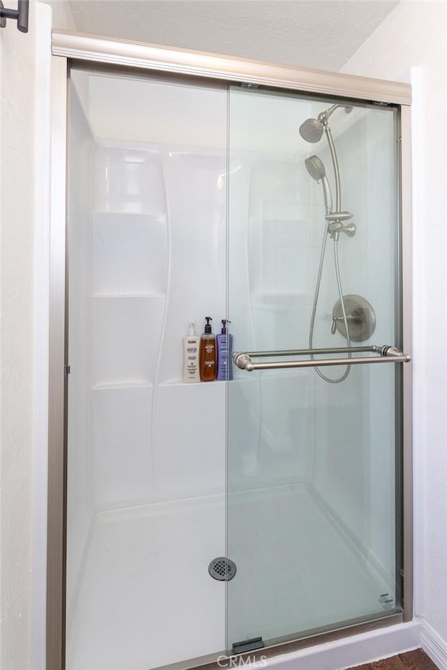 bathroom with a shower with door