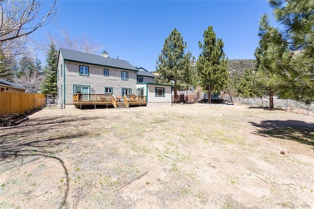 rear view of house featuring a wooden deck