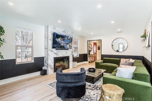 living room with a fireplace and light hardwood / wood-style flooring