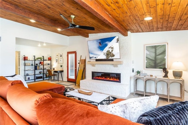 living room with ceiling fan, wooden ceiling, vaulted ceiling with beams, light hardwood / wood-style floors, and a fireplace