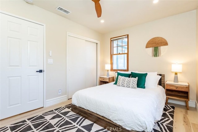 bedroom featuring wood-type flooring, a closet, and ceiling fan