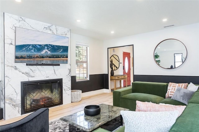 living room with hardwood / wood-style floors and a fireplace