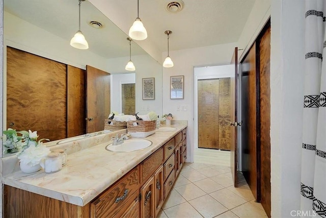 bathroom with tile patterned flooring and vanity