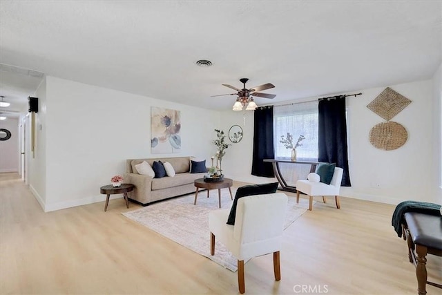 living room featuring ceiling fan and light wood-type flooring