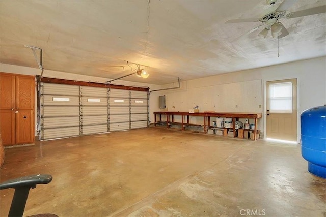 garage with electric panel, a garage door opener, and ceiling fan