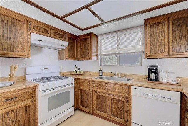 kitchen featuring white appliances and sink