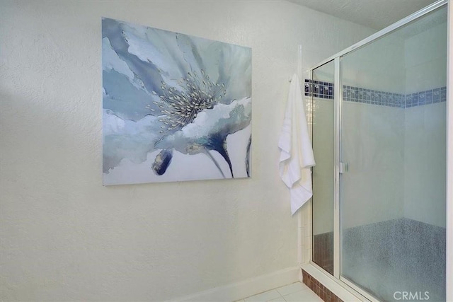 bathroom featuring tile patterned flooring and a shower with shower door