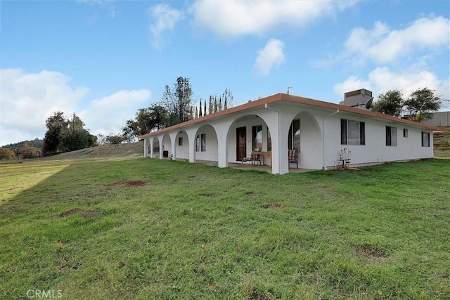 exterior space with a lawn and a patio