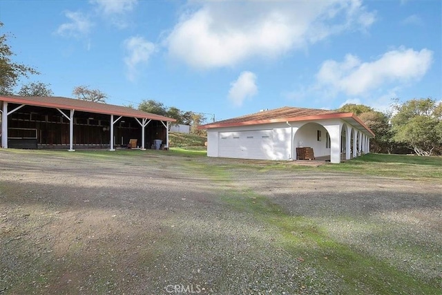 view of front of home featuring an outbuilding