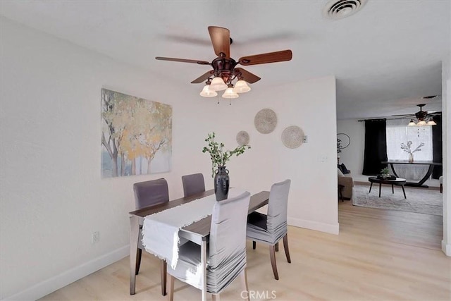 dining area with ceiling fan and light wood-type flooring