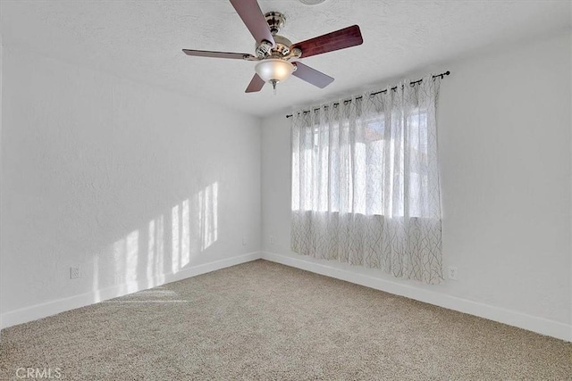 spare room featuring a textured ceiling, carpet floors, and ceiling fan