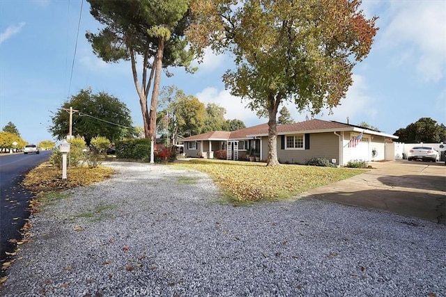 ranch-style house with gravel driveway