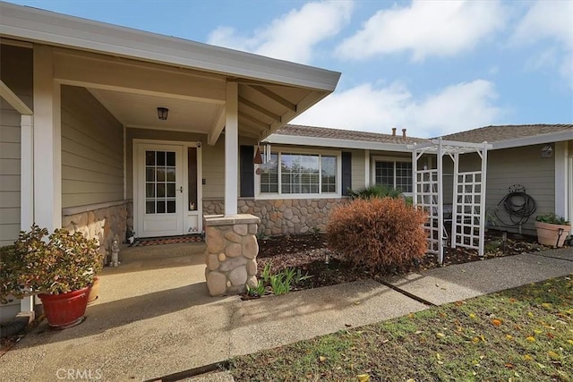 doorway to property with stone siding