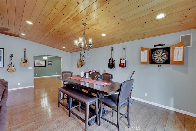 dining room featuring wood ceiling, light wood-style flooring, arched walkways, and recessed lighting